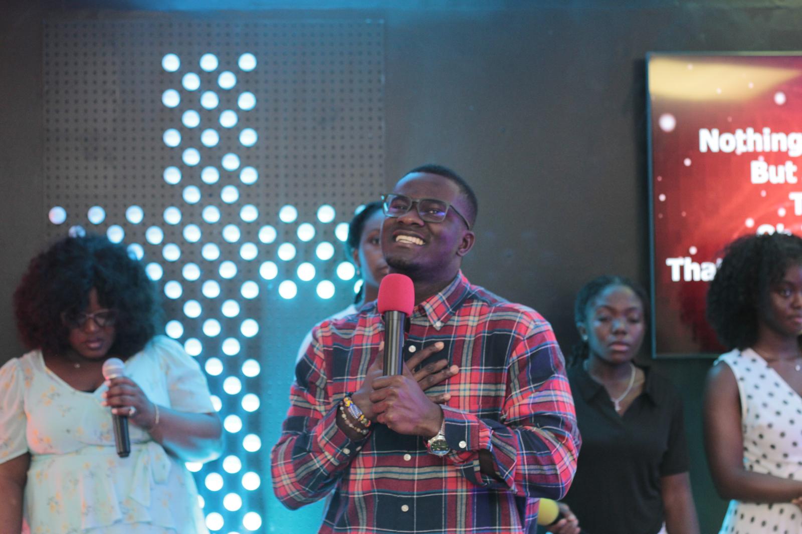 Gabriel teaching on stage with a microphone